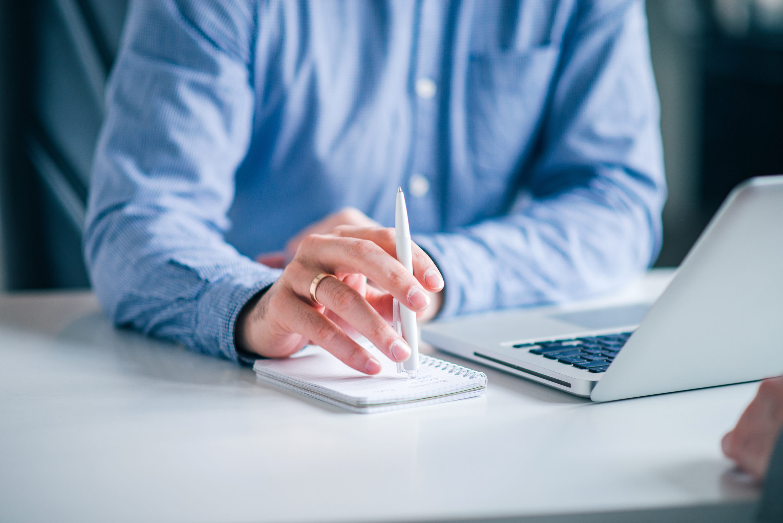 Close-up image of businessman taking notes.